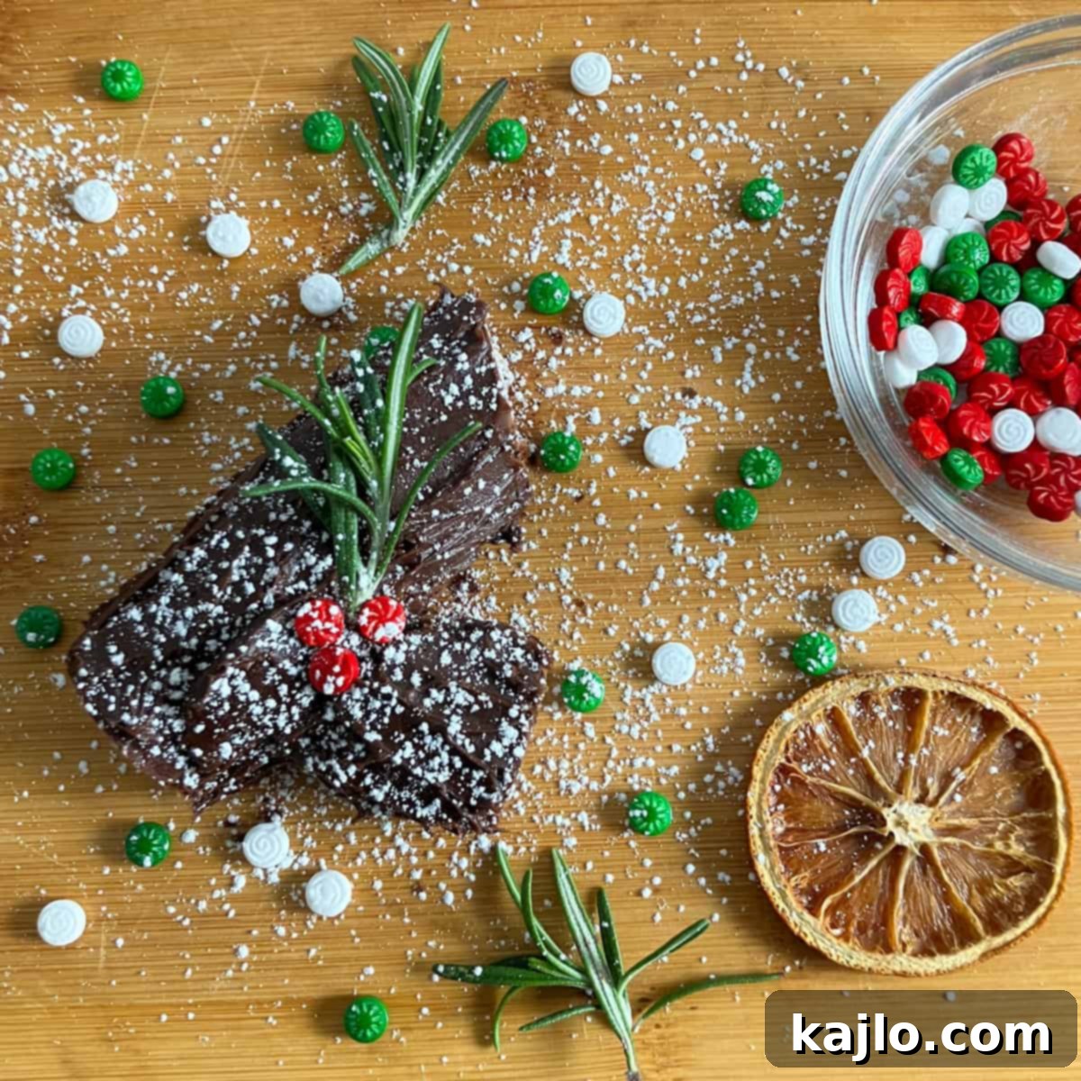 Child's hands decorating a Yule log craft with various toppings.