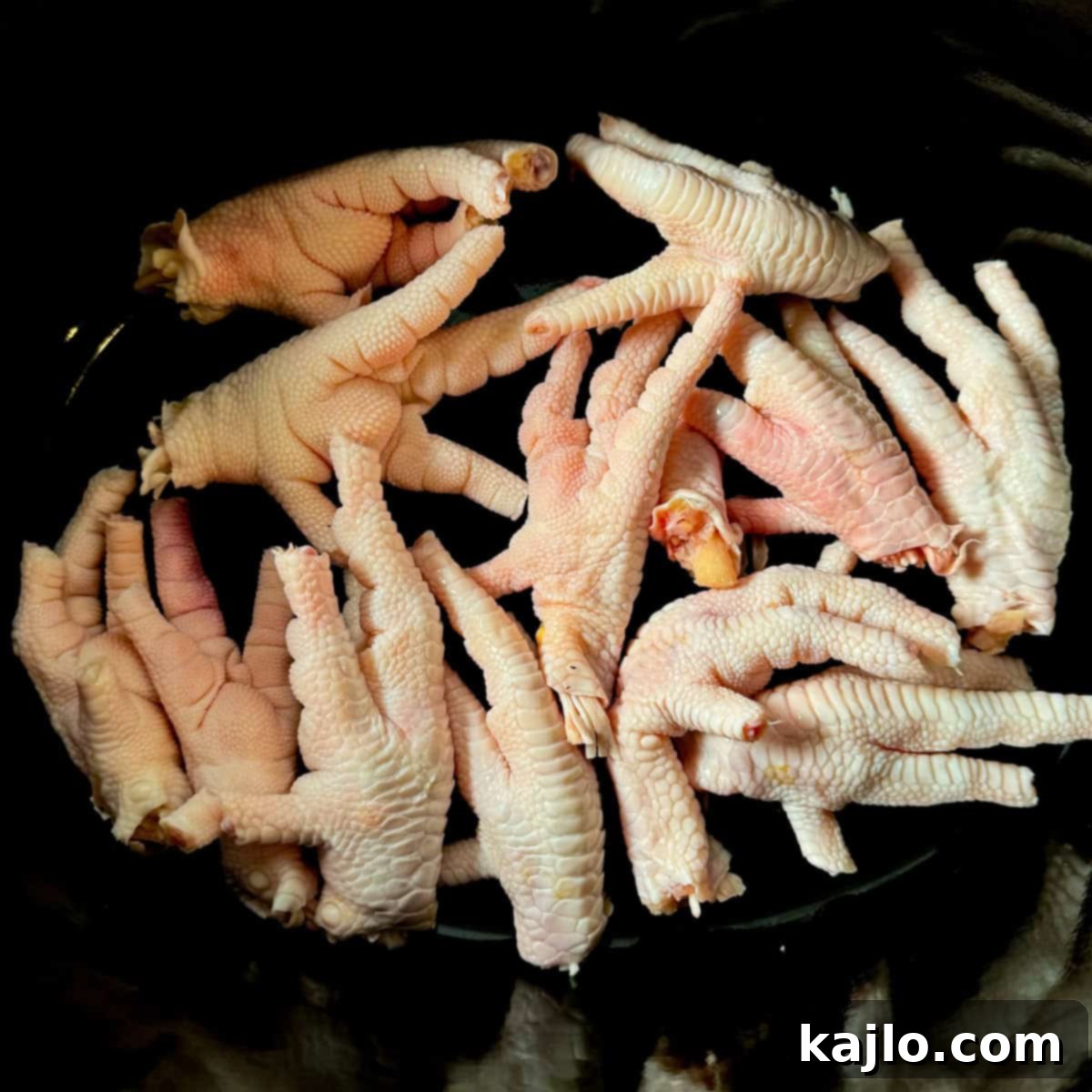 Chicken feet simmering in a slow cooker for broth