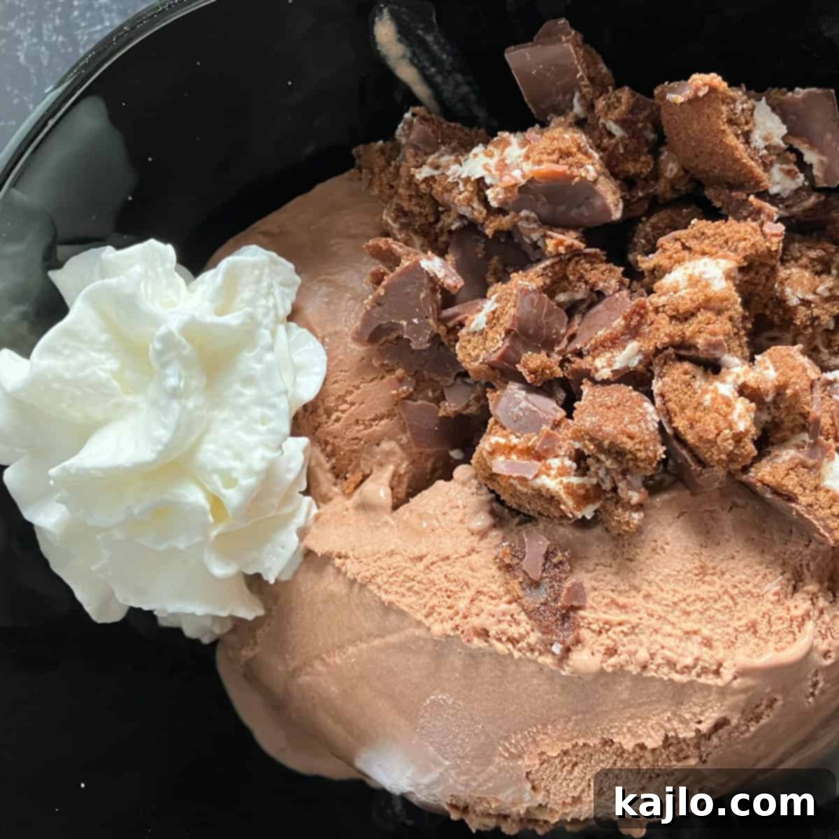 DIY Swiss Roll Ice Cream 5 Gently mixing whipped cream into chocolate ice cream with chopped Swiss roll pieces