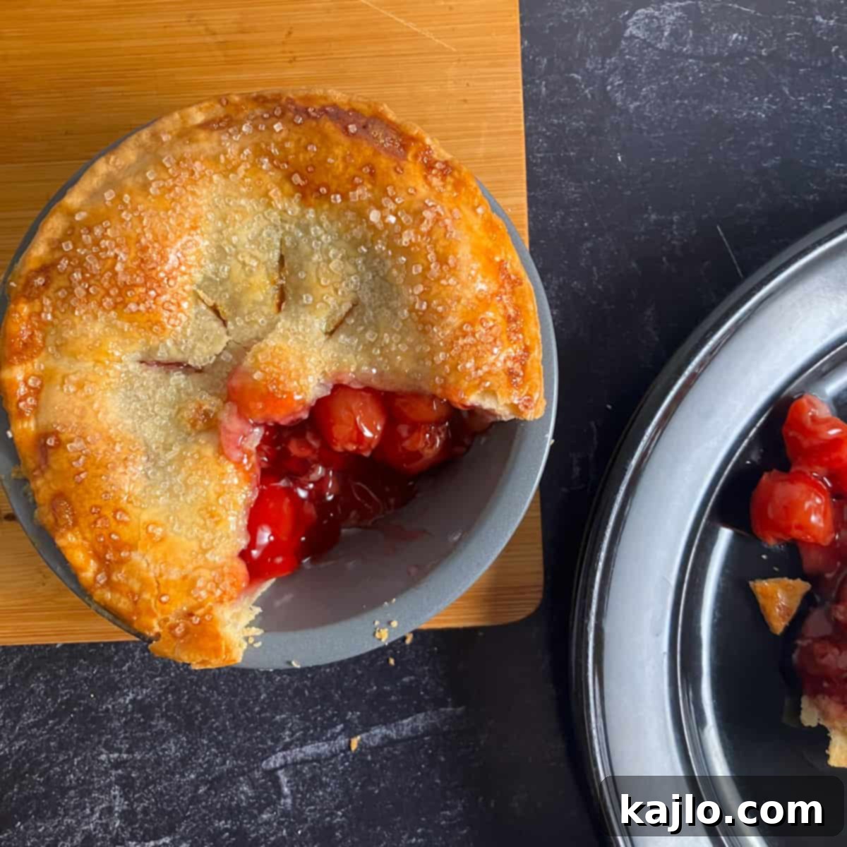 Air Fryer Mini Cherry Pies 6 Close-up of a perfectly baked cherry pie, golden and with visible hot filling, made in an air fryer.