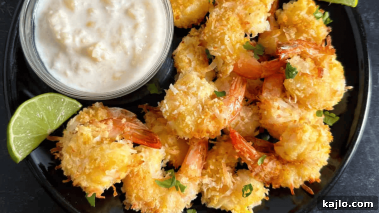 Crispy air fryer coconut shrimp with a side of vibrant pineapple dipping sauce