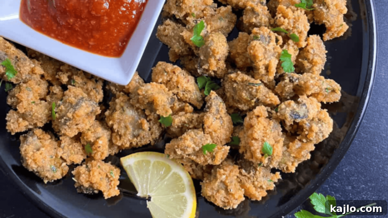 Crispy air fryer oysters served elegantly with lemon wedges