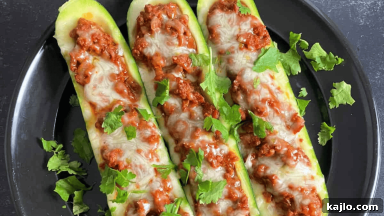keto zucchini boats, hollowed-out zucchini halves stuffed with spicy chorizo, tomatoes, onions, and melted cheese
