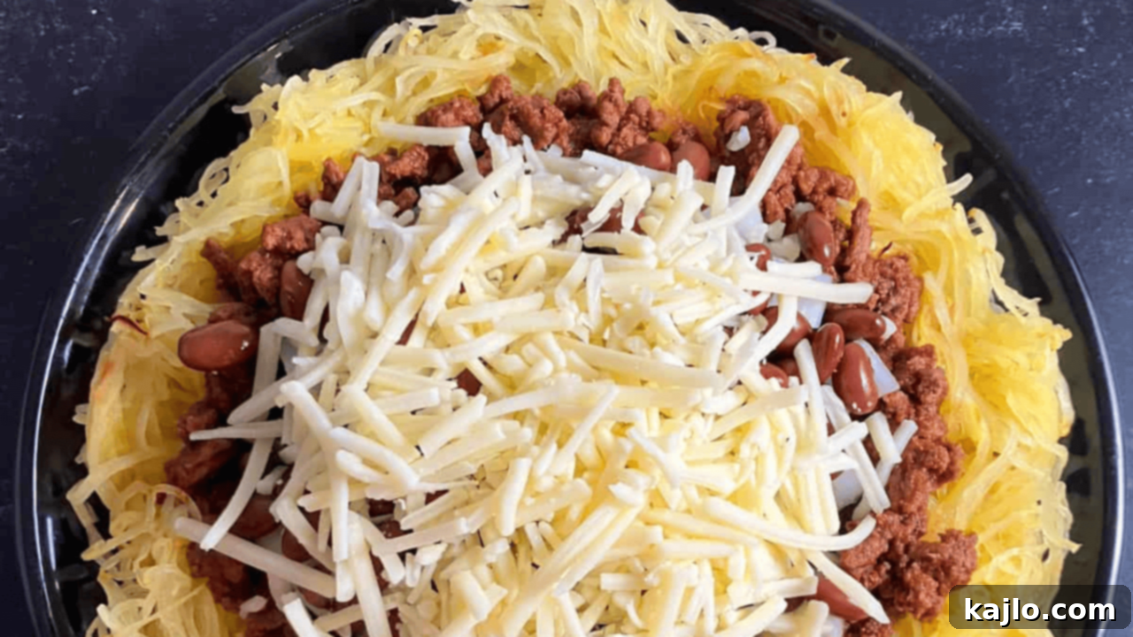 Keto Cincinnati Chili, made with ground beef simmered in a rich blend of spices, served over spaghetti squash for a hearty, low-carb meal
