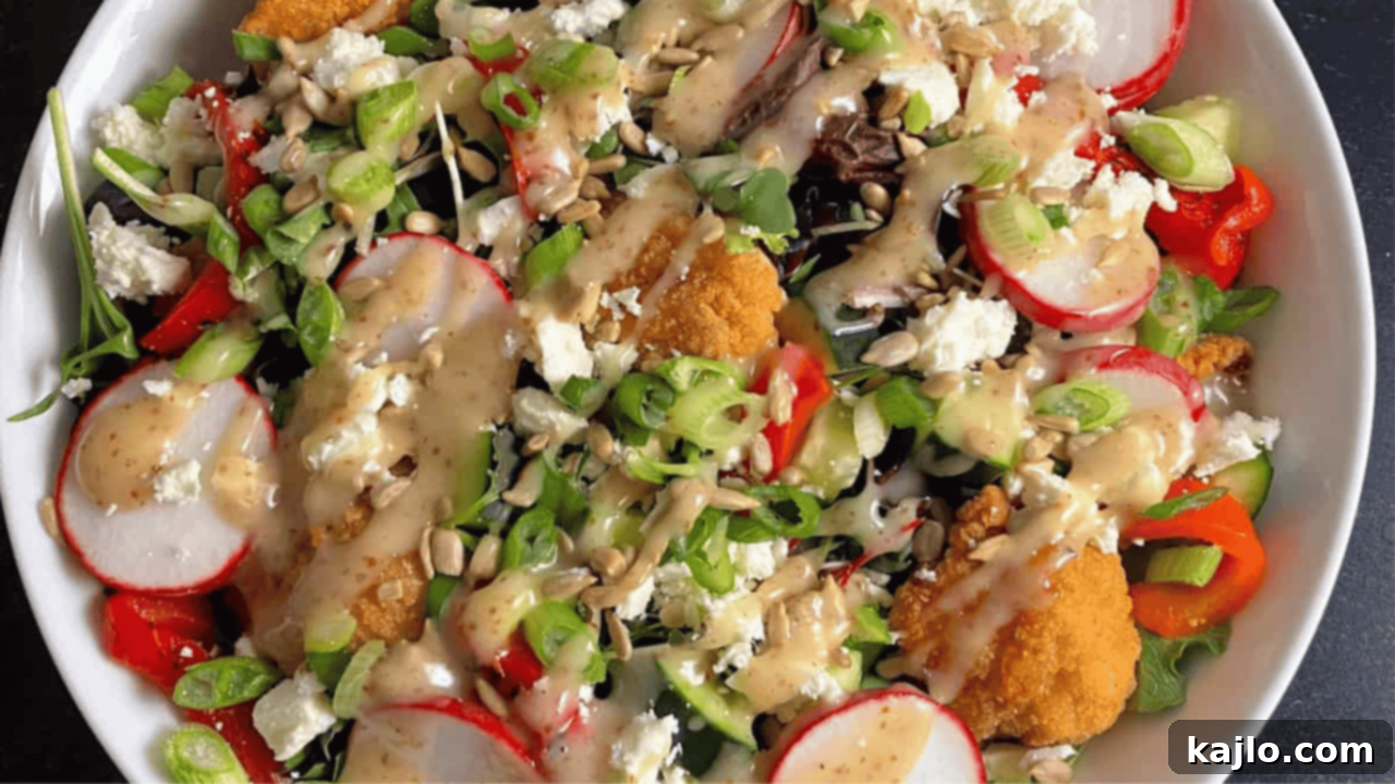 My 70-Pound Transformation: What Really Worked 10 A vibrant popcorn chicken bowl salad, featuring crispy popcorn chicken paired with fresh greens and radishes, topped with honey mustard dressing.