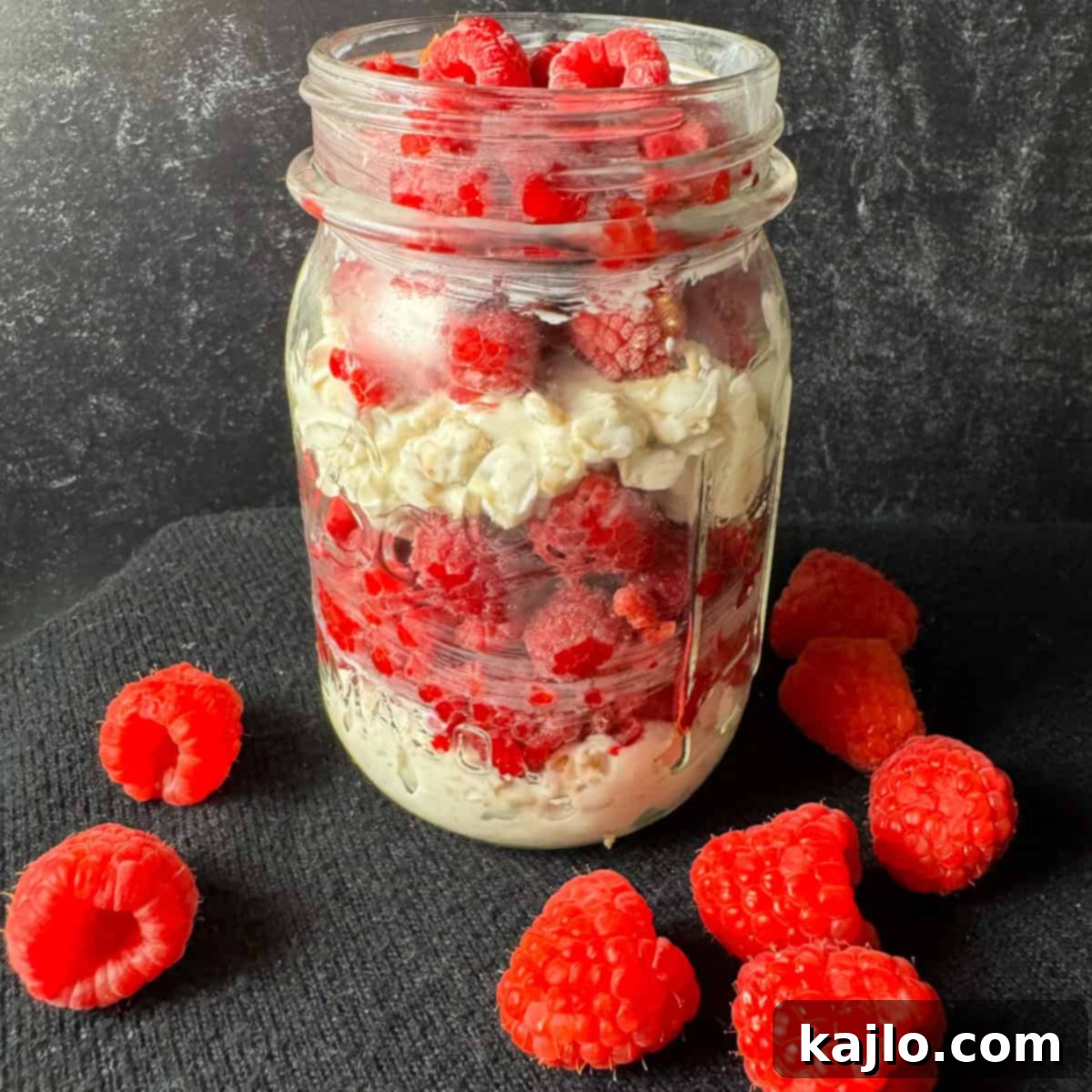 Overnight Oats: Your Favorite Frozen Fruit Creation 5 Layering frozen fruit over the oat mixture in a mason jar.