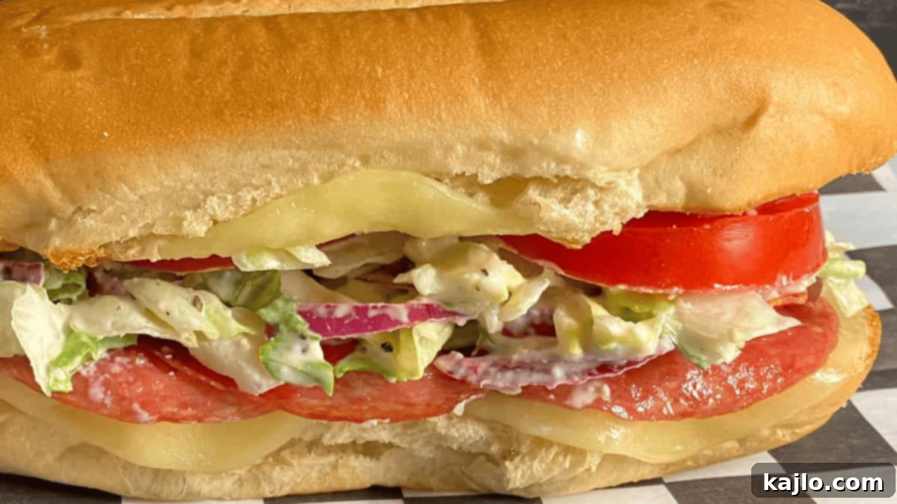 TikTok viral Grinder Sandwich stacked with deli meats and fresh salad