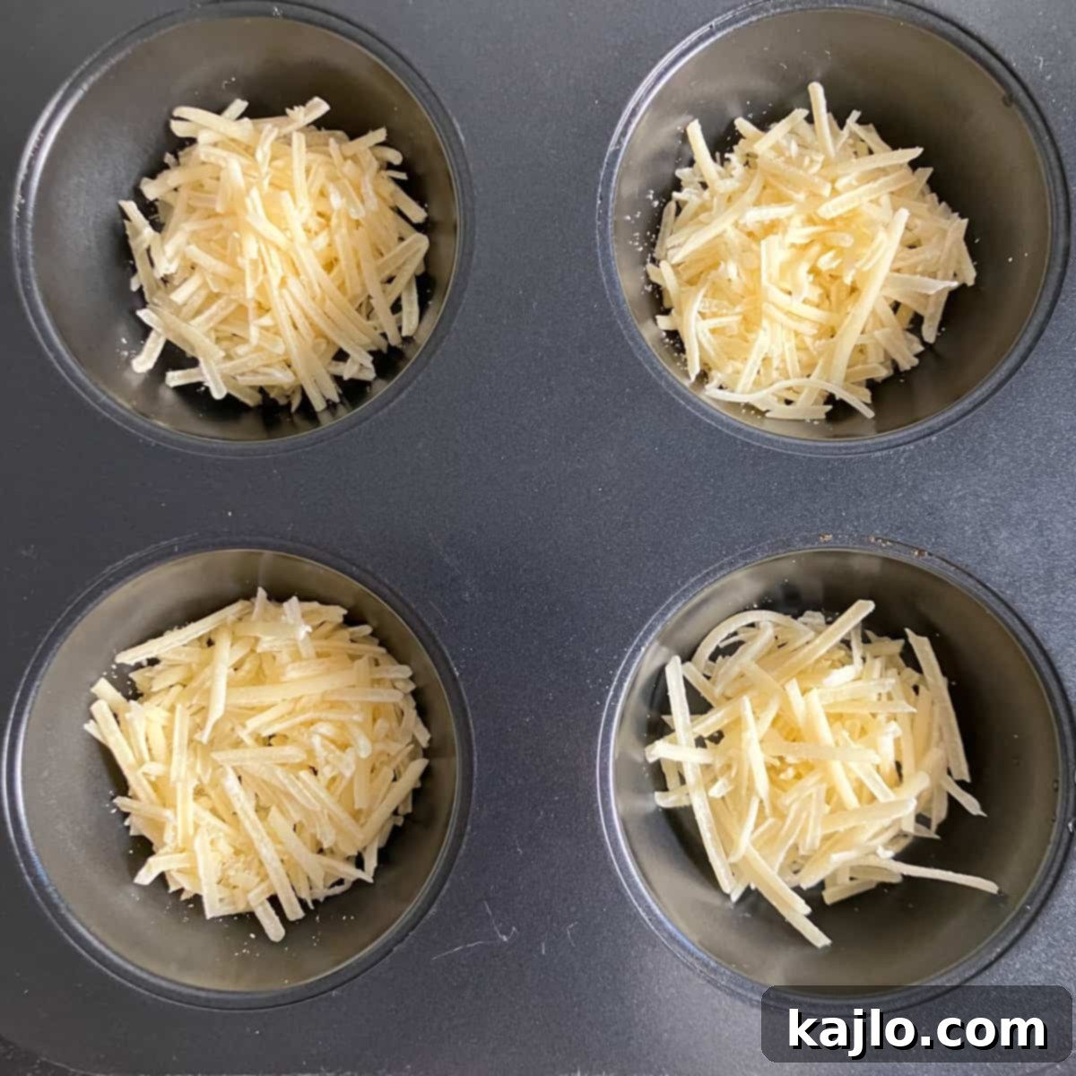 Parmesan cheese expertly placed in a muffin tin, ready for air frying.