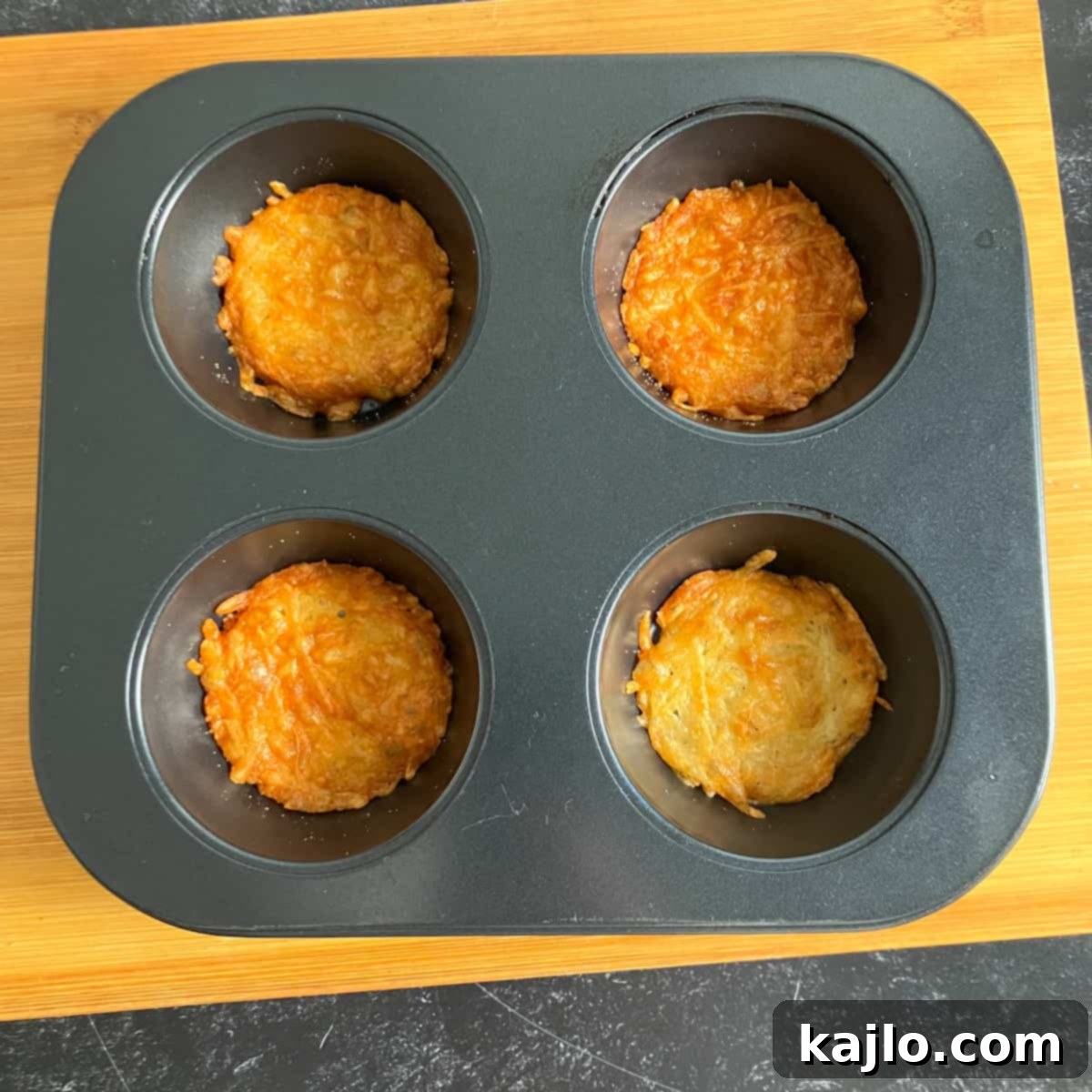 Golden-brown Parmesan crisps cooking in an air fryer, nearly ready.