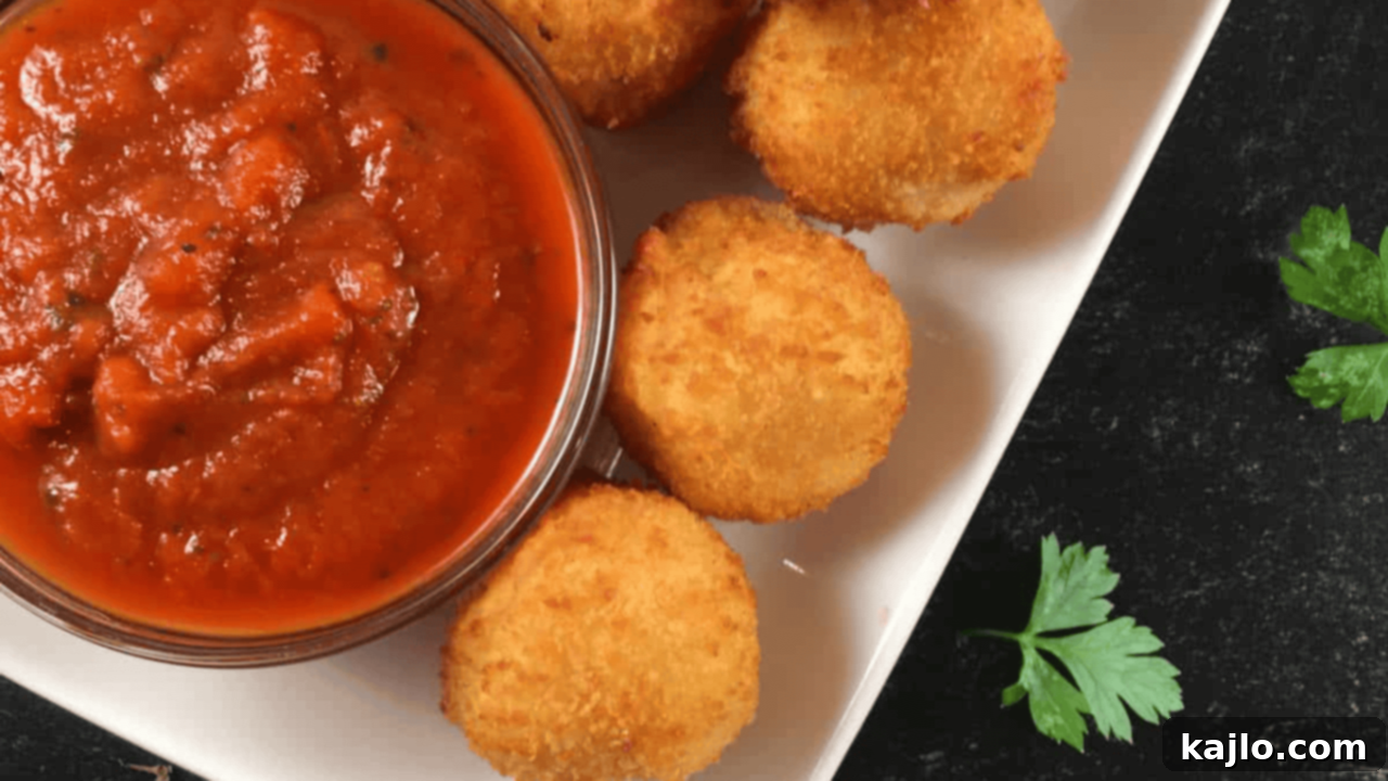 10 Irresistible Starters for Your Perfect Night In 2 Crispy golden Trader Joe's Mac and Cheese Bites cooked in an air fryer, served on a plate.