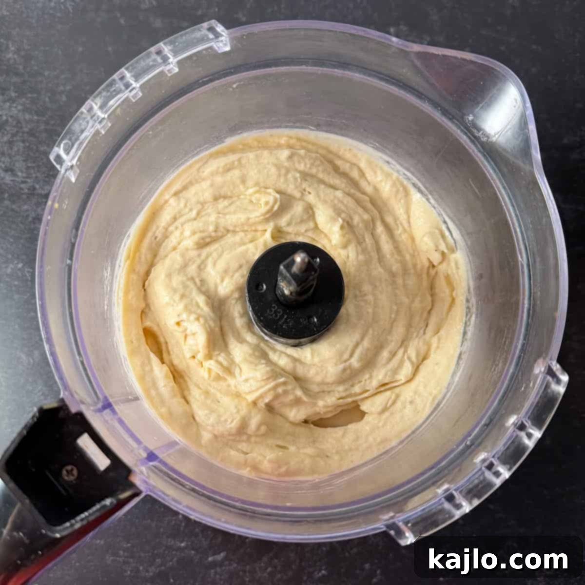 Homemade DK Crush Float 6 Pineapple banana Dole whip being blended in a food processor.