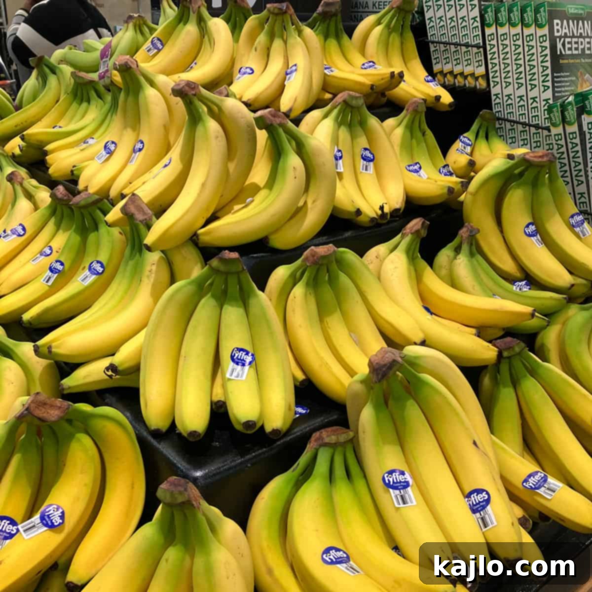 The World of B Fruits Over 40 Varieties Revealed 3 A bunch of ripe yellow bananas on a wooden surface.