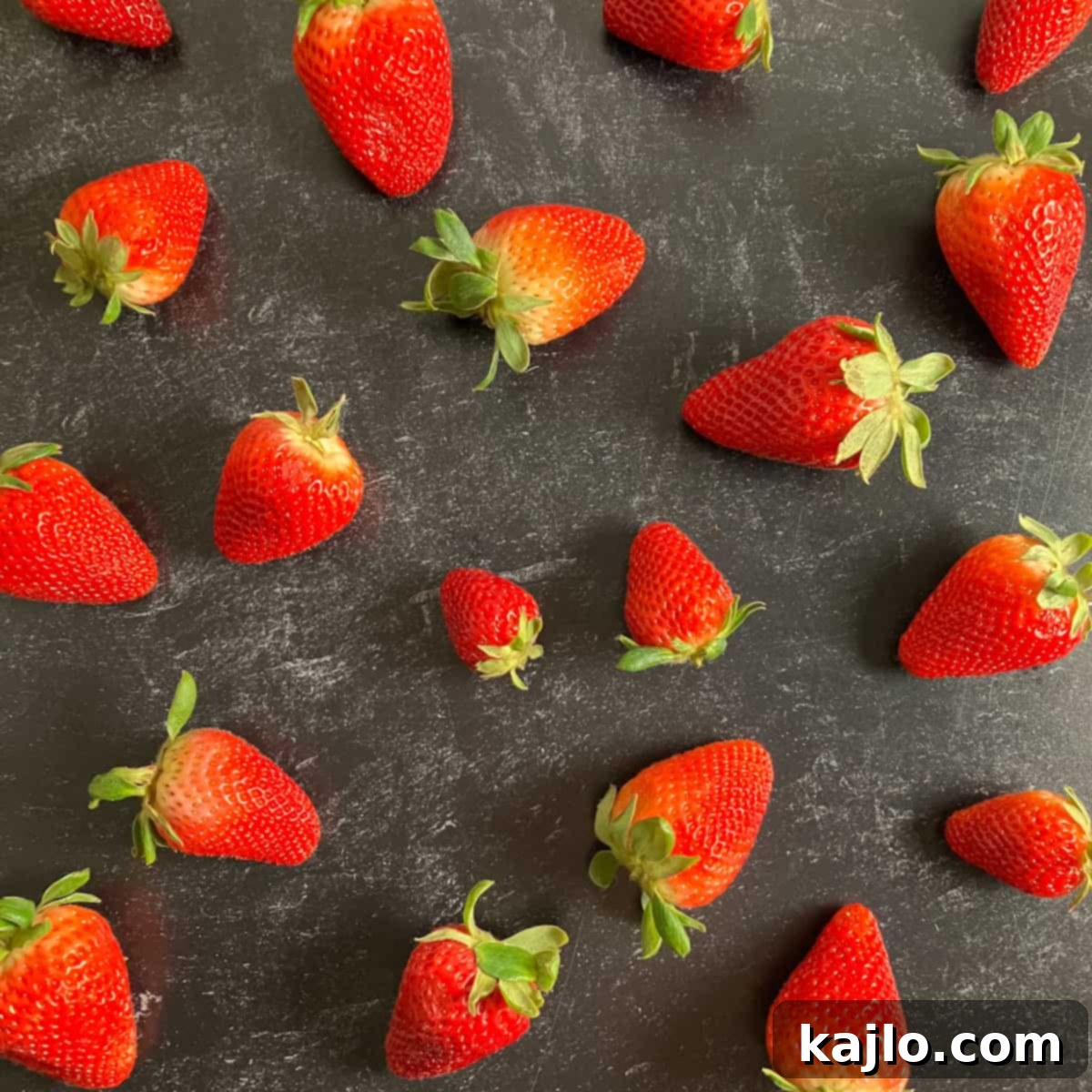 The World of B Fruits Over 40 Varieties Revealed 4 A mix of fresh, colorful berries in a bowl, including strawberries, blueberries, and raspberries.