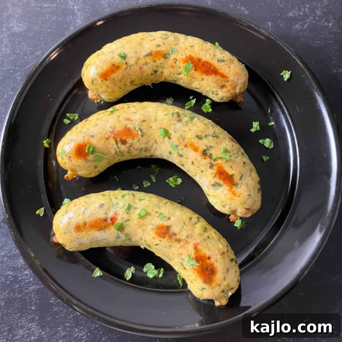 A large batch of homemade chicken sausage links stacked neatly, showcasing their uniform shape and appealing texture