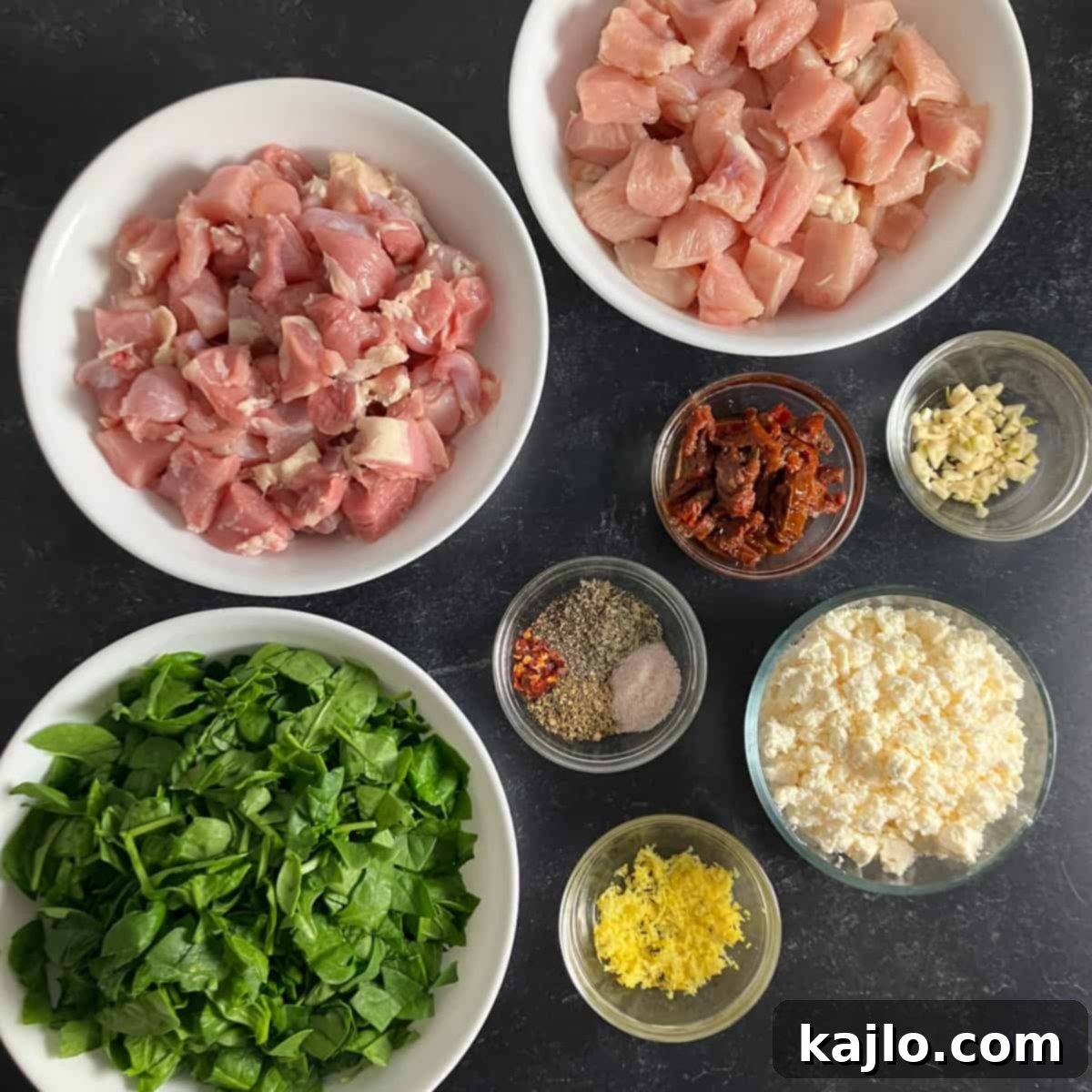 Individual ingredients laid out for homemade chicken sausage preparation