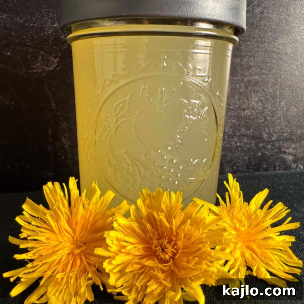 Homemade dandelion vinegar in a glass bottle, perfect for dressings and marinades