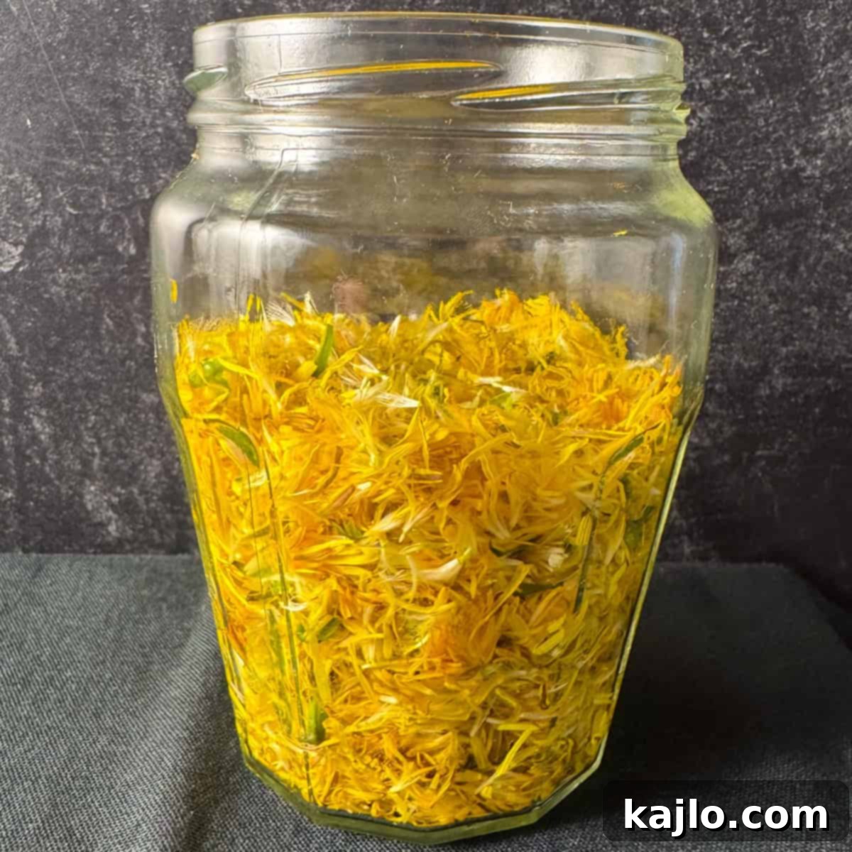 Vibrant yellow dandelion petals separated from green parts, ready for vinegar making