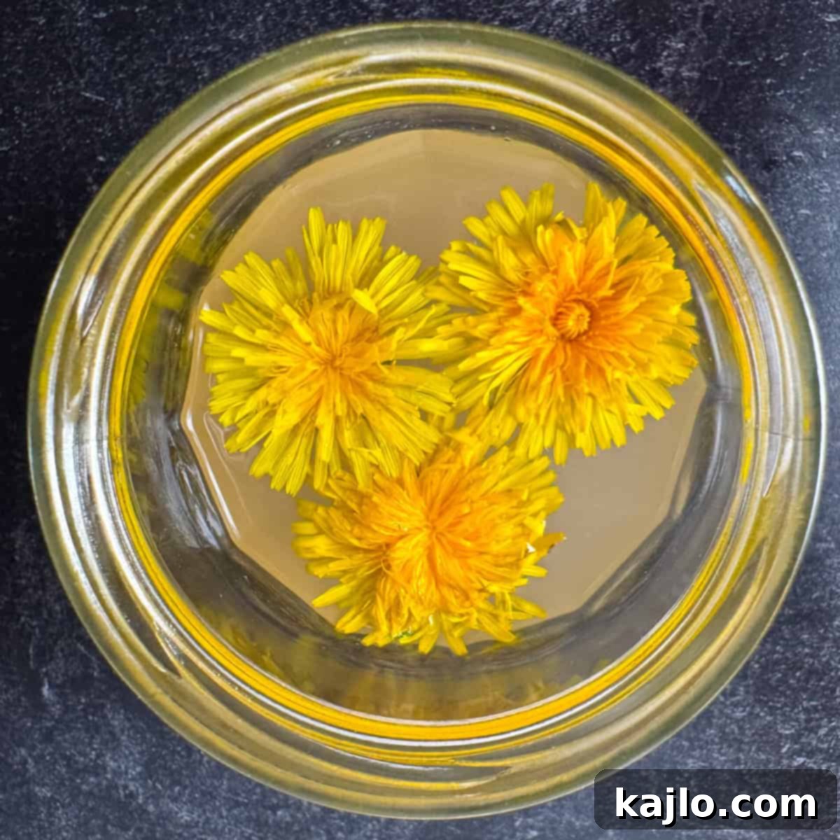 Finished dandelion vinegar in a glass jar, ready for use