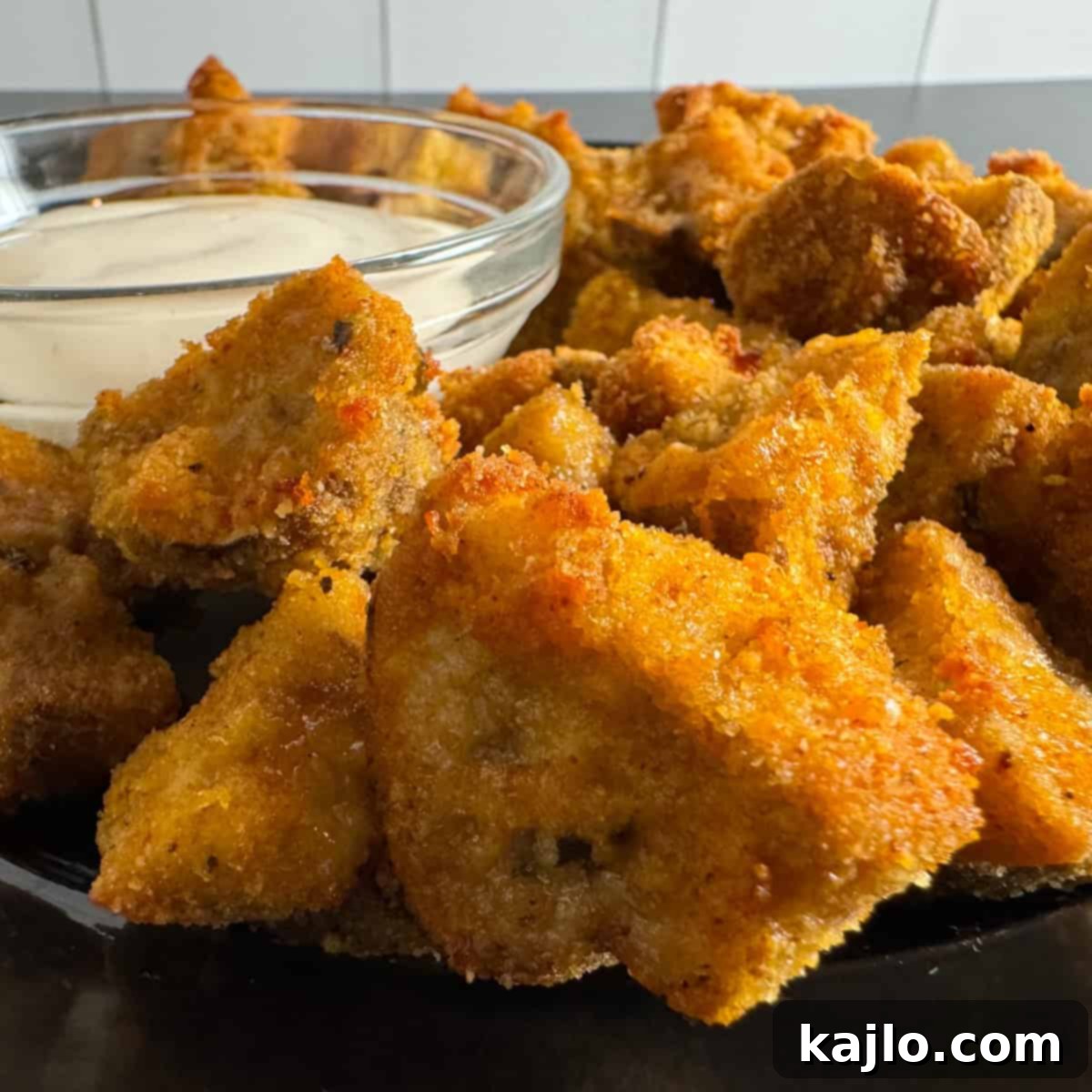Close-up of golden breaded mushroom in air fryer