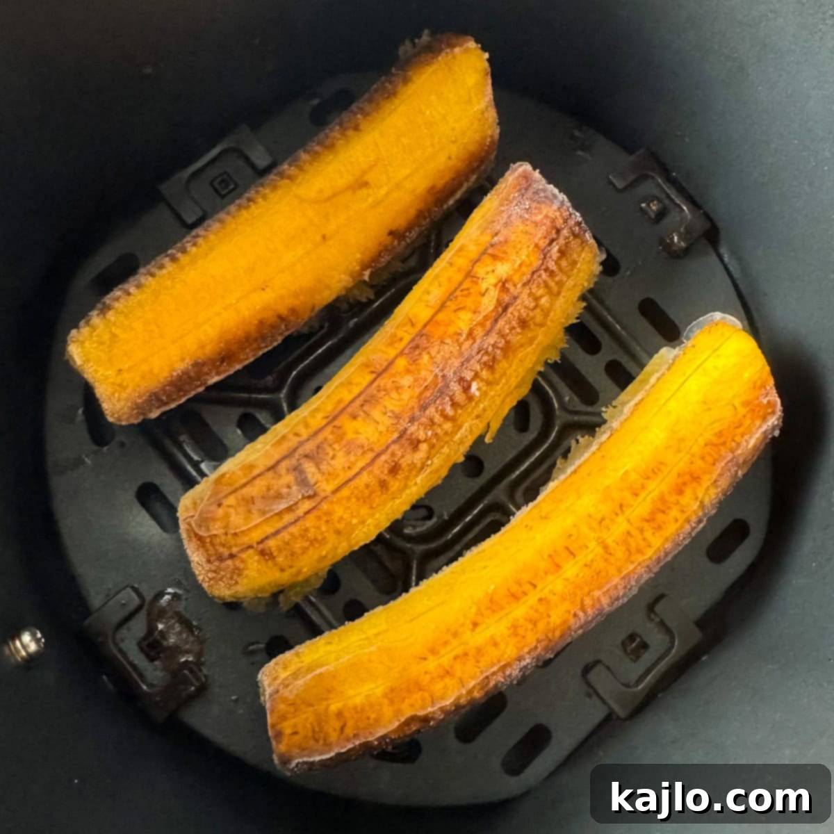 Air Fried Frozen Plantains Sweet Maduros and Savory Tostones 5 Frozen maduros cooking in an air fryer basket, beginning to brown.