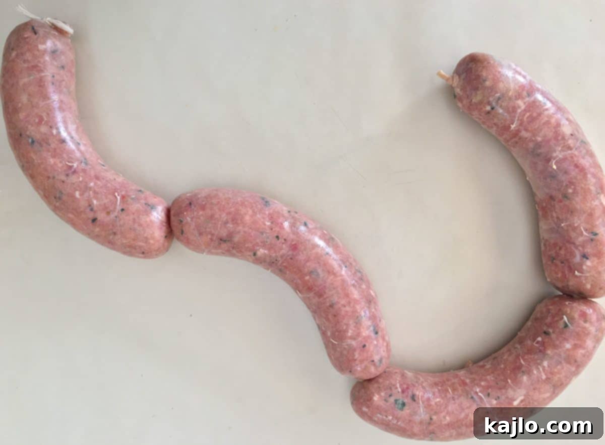 Sweet Italian sausage links neatly tied with kitchen twine, ready for cooking or storage.