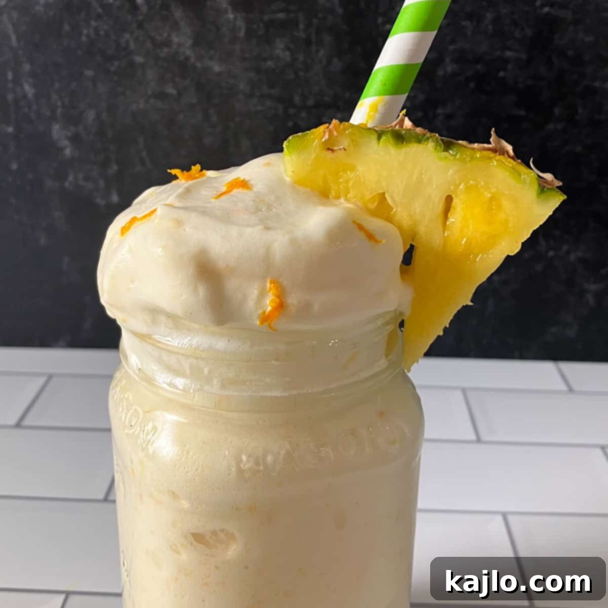 Guilt-Free Peach Pineapple Smoothie 7 Completed peach pineapple smoothie recipe served in two glasses with wide straws