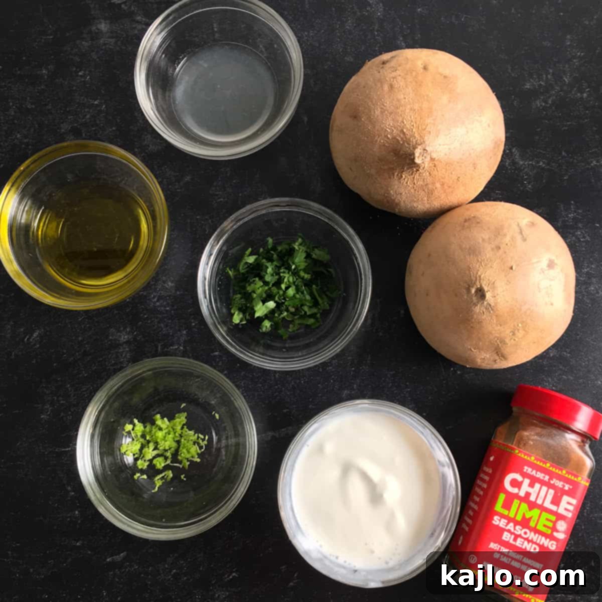 Crispy Air Fryer Jicama Fries with Creamy Keto Vegan Dip 4 Ingredients for air fryer jicama fries and the cilantro-lime dipping sauce, including a peeled jicama, olive oil, tajin, yogurt, cilantro, and limes.