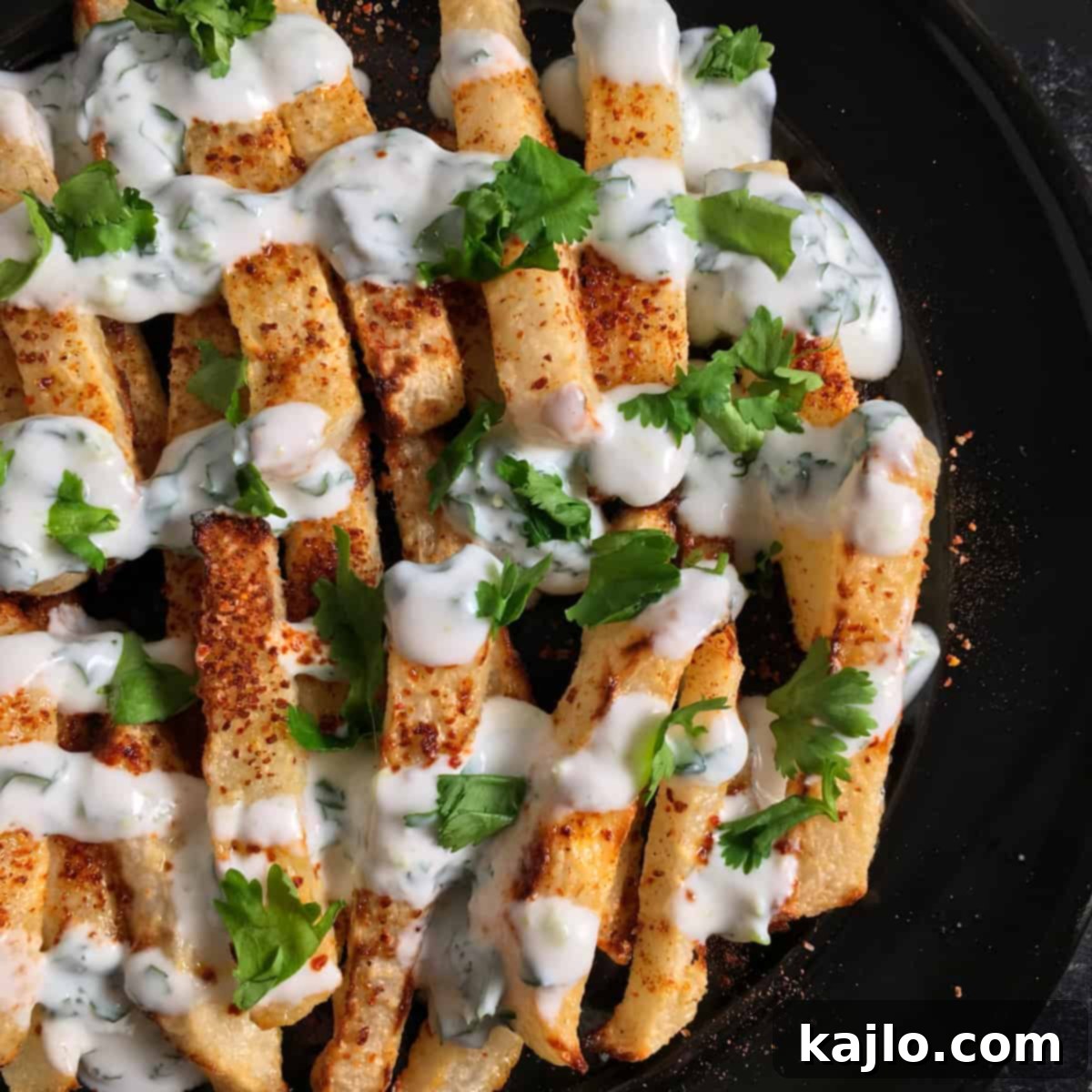 Crispy Air Fryer Jicama Fries with Creamy Keto Vegan Dip 6 A pile of air fryer jicama fries in a bowl, showing their crispy texture and golden-brown edges.