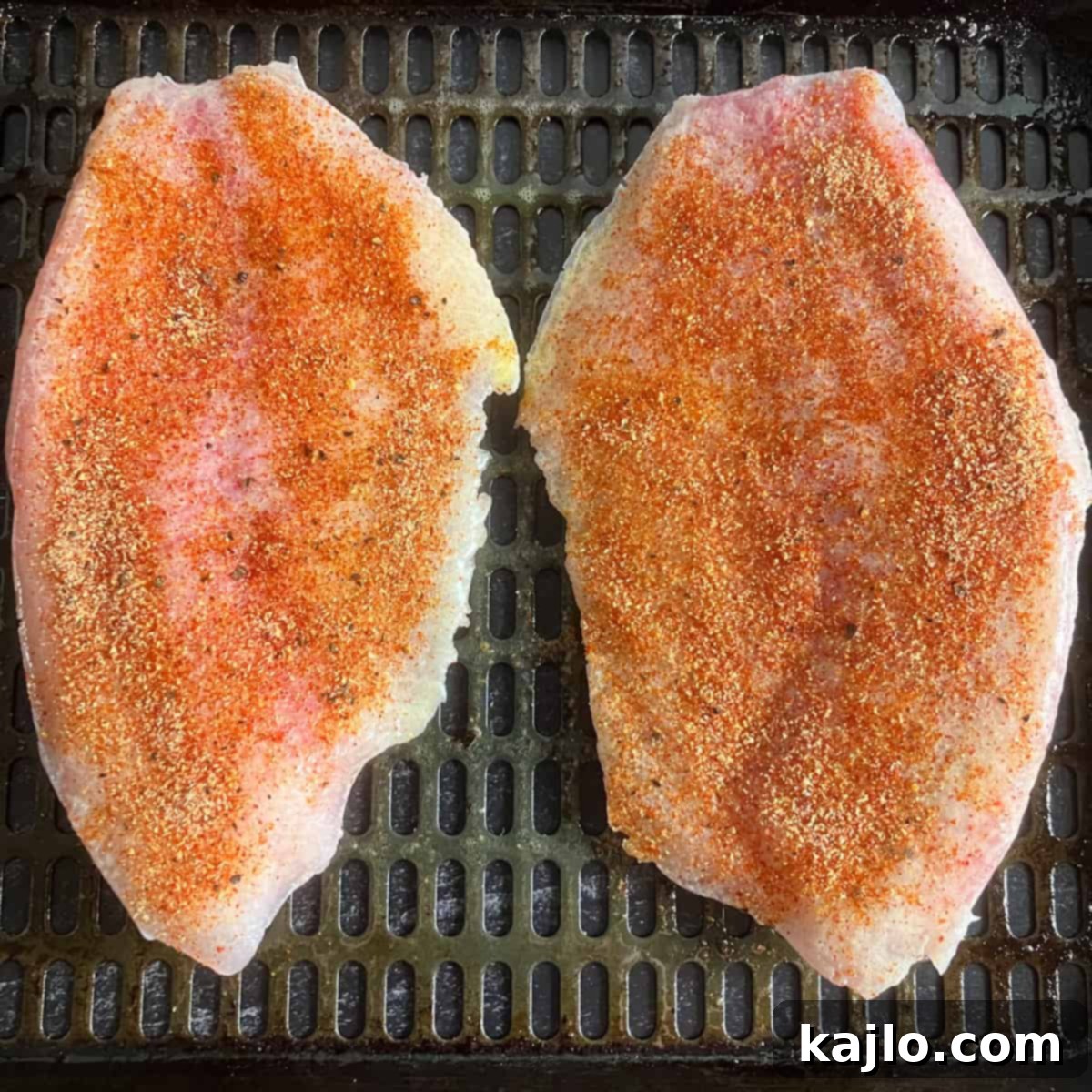Easy Air Fryer Frozen Tilapia 4 Seasoning frozen tilapia fillets before air frying.