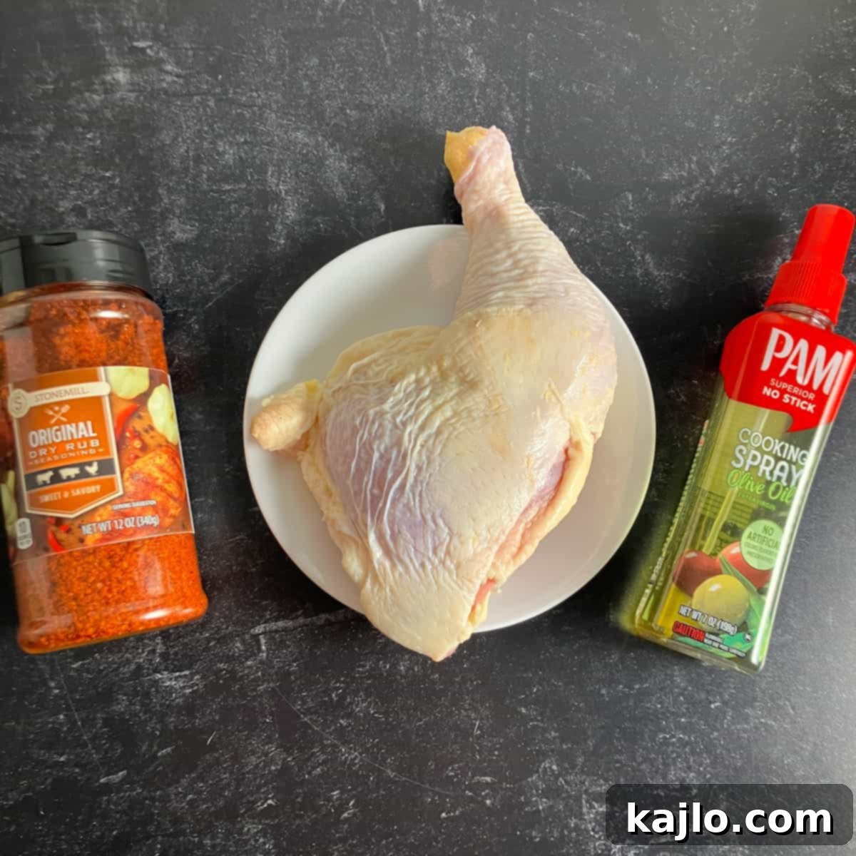 Ingredients for air fryer chicken leg quarters: chicken, seasoning, and cooking spray