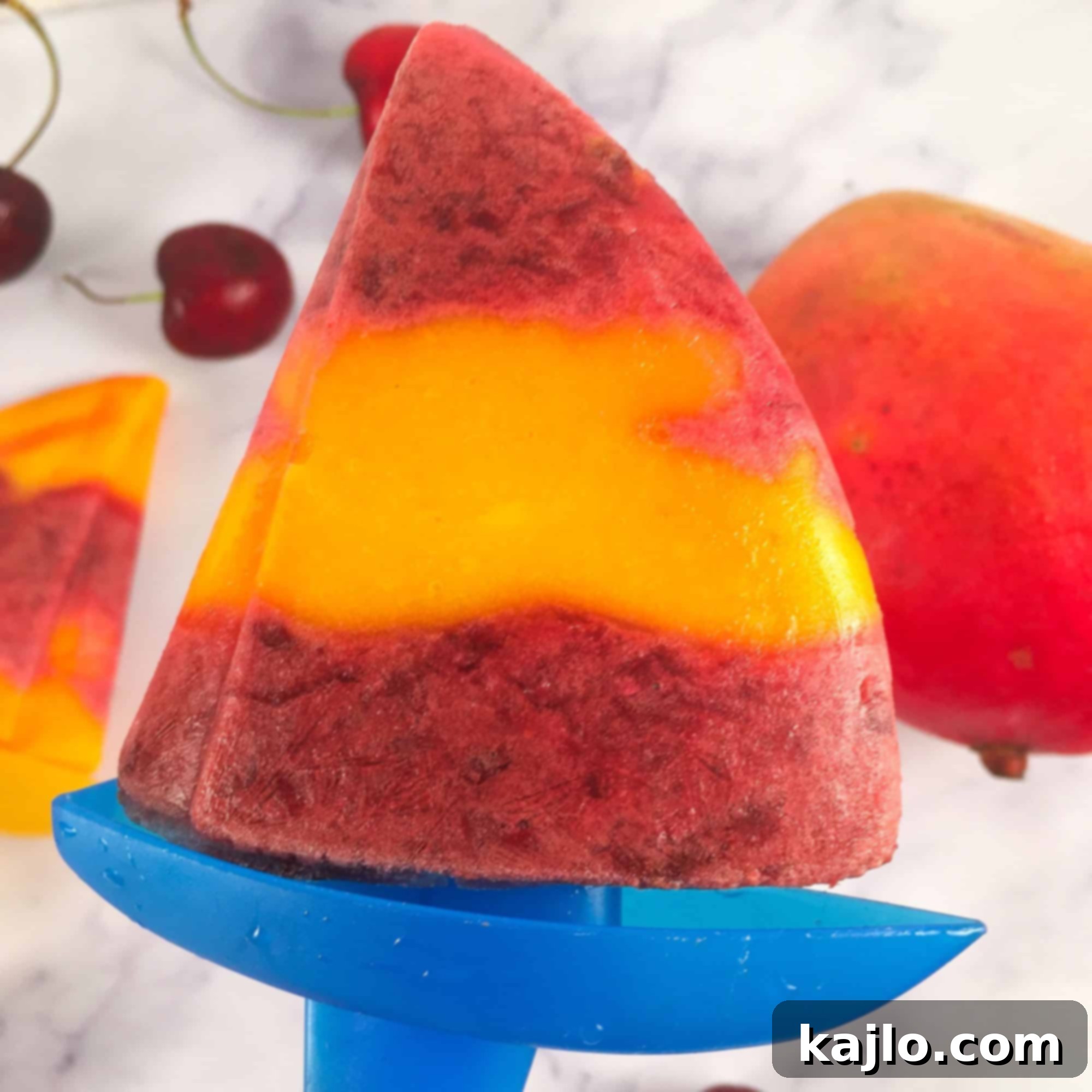 Summer Cherry Mango Pops 7 Sailboat popsicles with cherry and mango layers