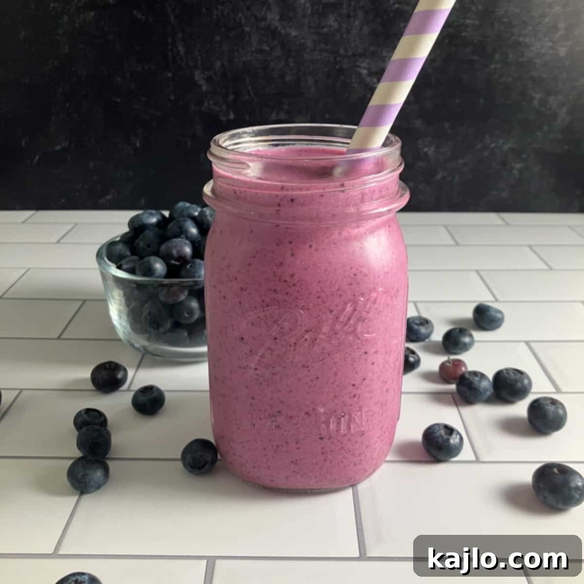 Refreshing peach blueberry smoothie in a glass with fresh fruits