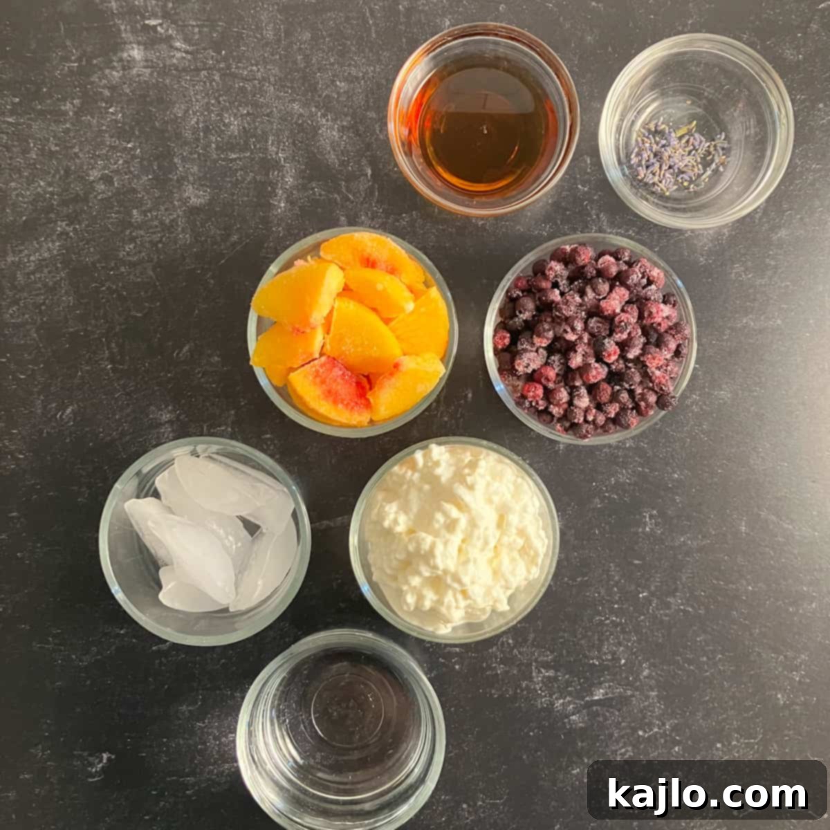 Ingredients for peach blueberry smoothie laid out on a table