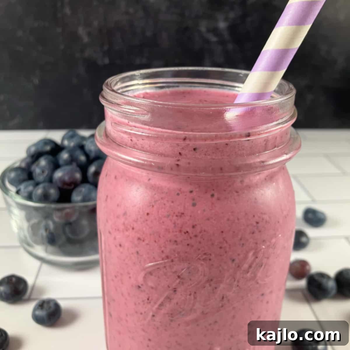 Two glasses of peach blueberry smoothie ready to be served