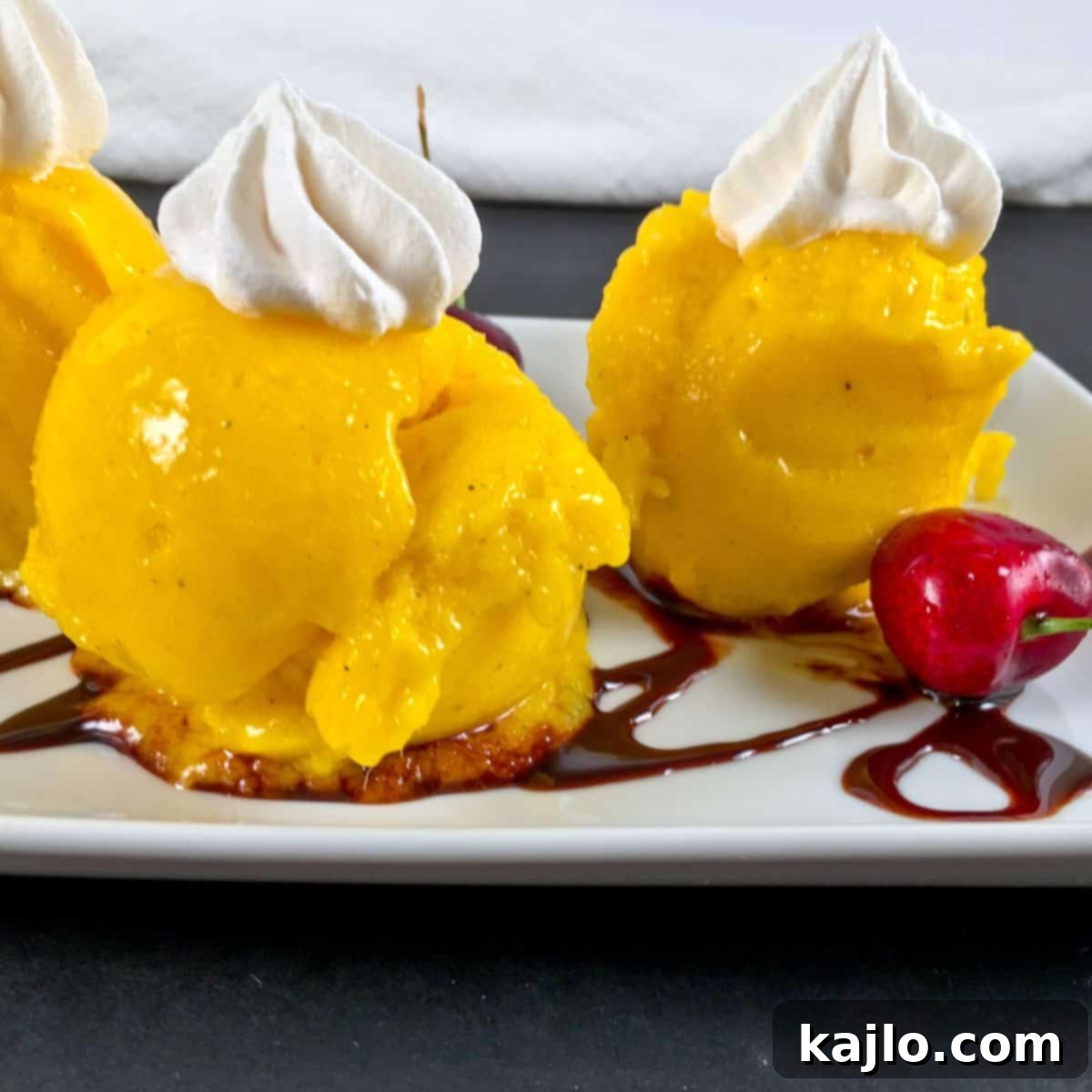 Creamy Sugar Free Mango Nice Cream 4 Melting mango nice cream with whipped cream and chocolate sauce
