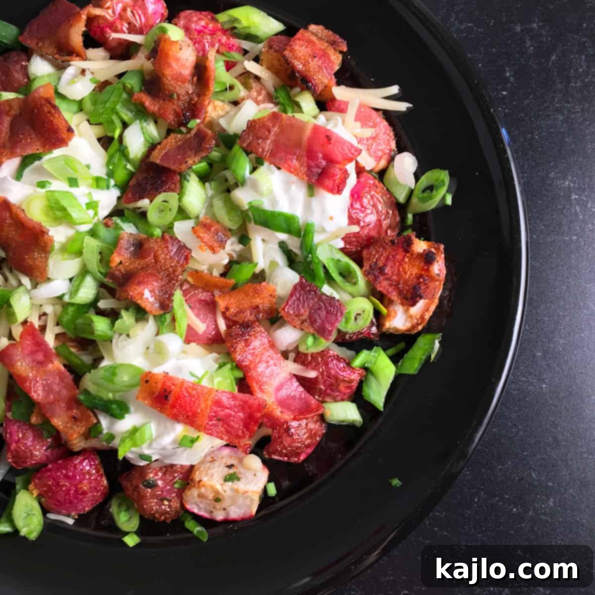 A beautifully plated dish of air fryer radishes with all the loaded toppings.